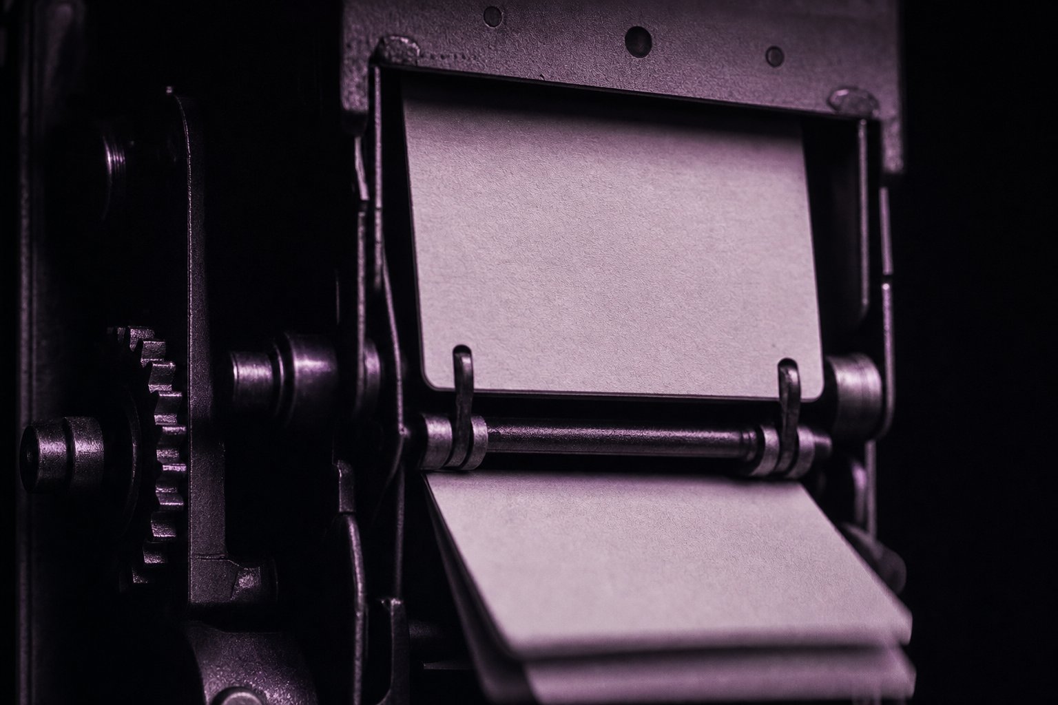 An extreme close-up of a mechanical countdown flap-clock mechanism with blank flaps, the last flap caught mid-fall